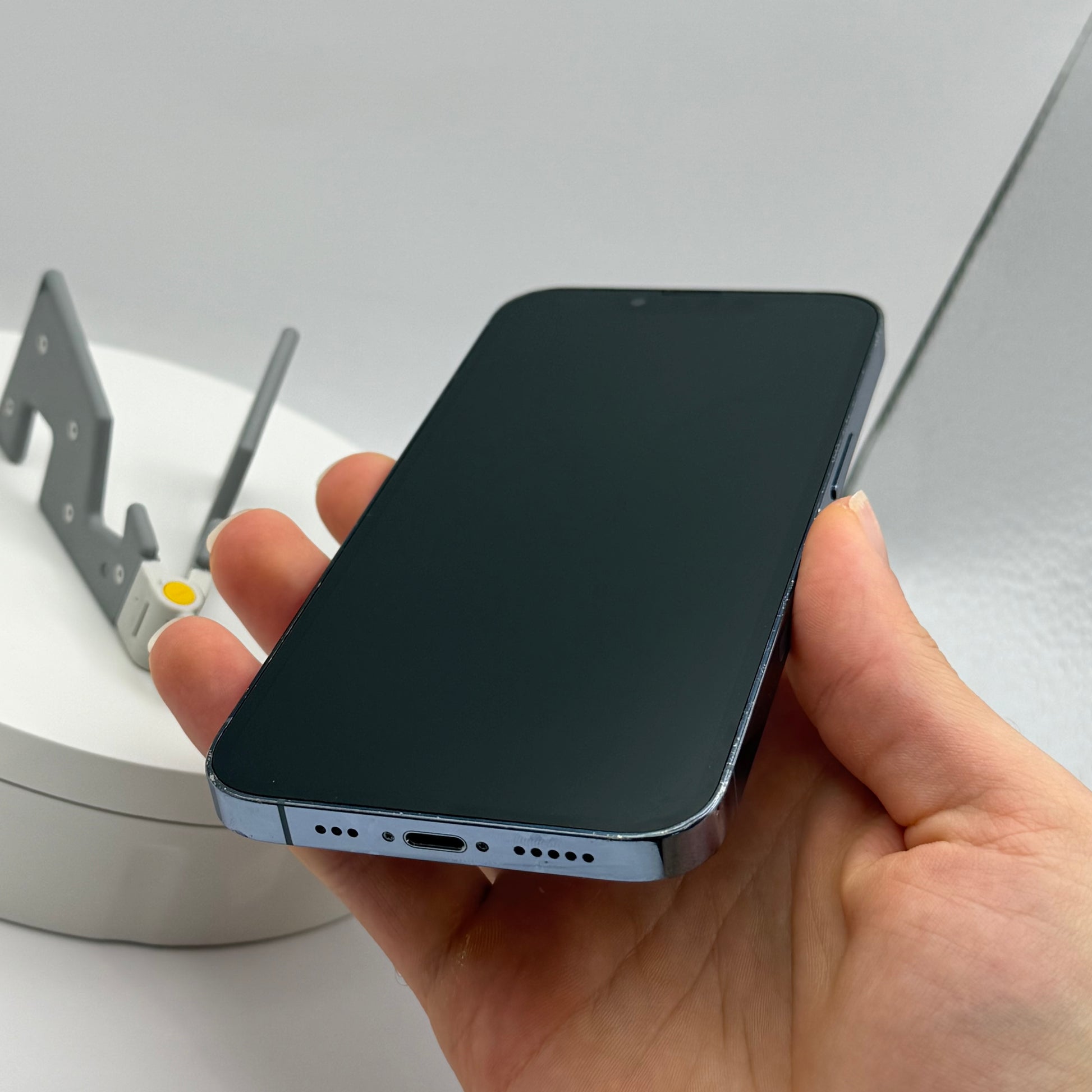iPhone 13 Pro Sierra Blue, front screen held in hand