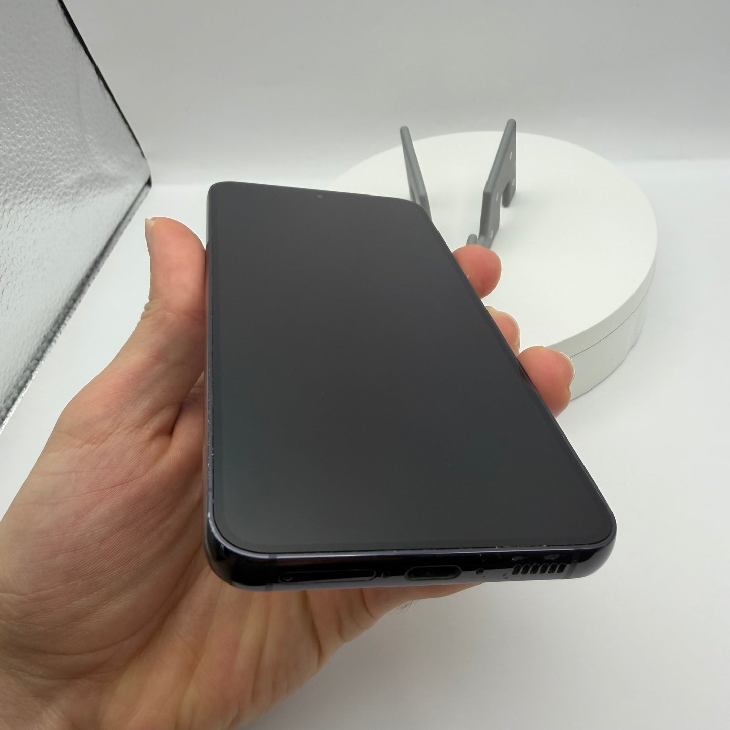 Samsung Galaxy S23 Phantom Black, front screen held in hand