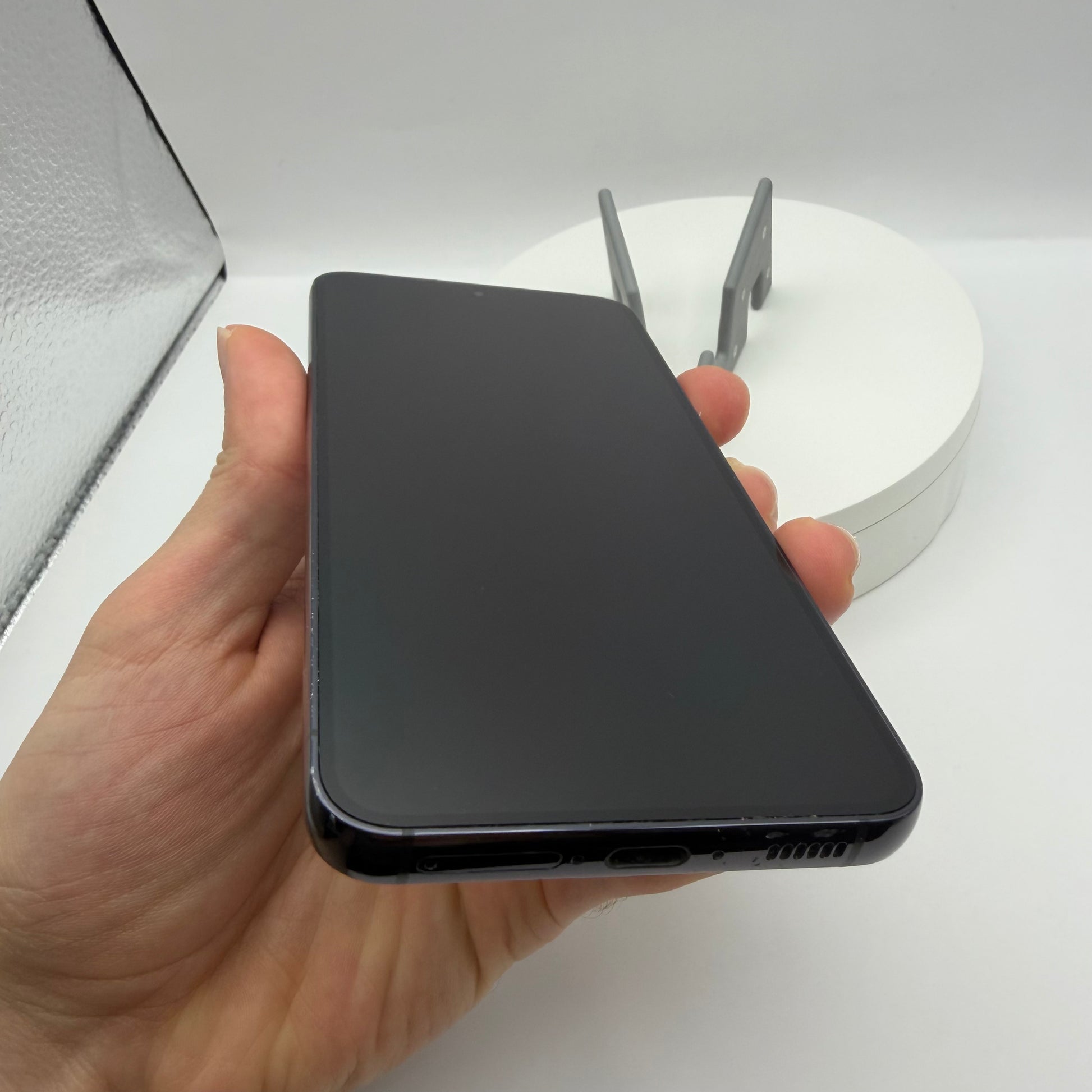 Samsung Galaxy S23 Phantom Black, front screen held in hand