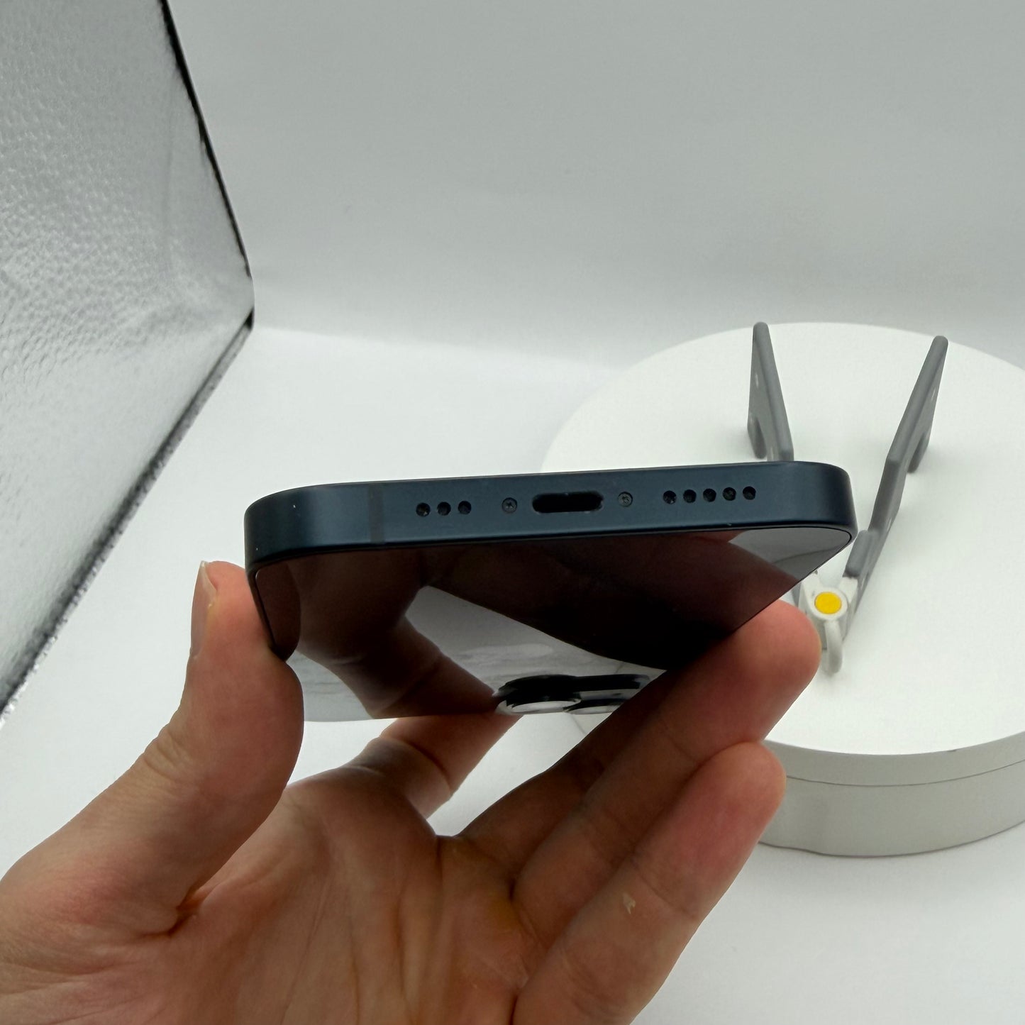 iPhone 13 Midnight bottom edge with Lightning port and speakers